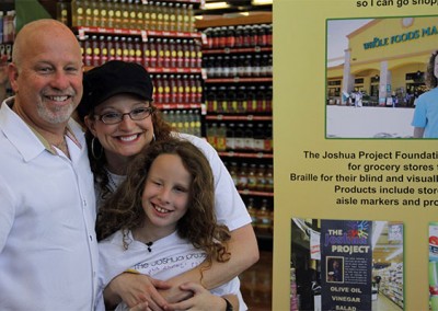 Joshua and his parents celebrate the launch of The Joshua Project at a Whole Foods store.